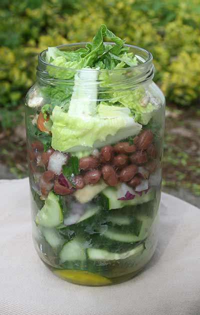 salad in a jar with beans, cucumbers, lettuce