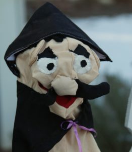 Haman the puppet with black mustache and pointy  black hat