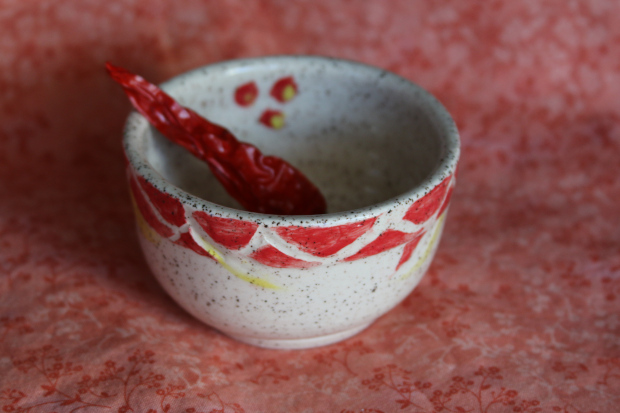 pot with red slip and bits of yellow, white stoneware