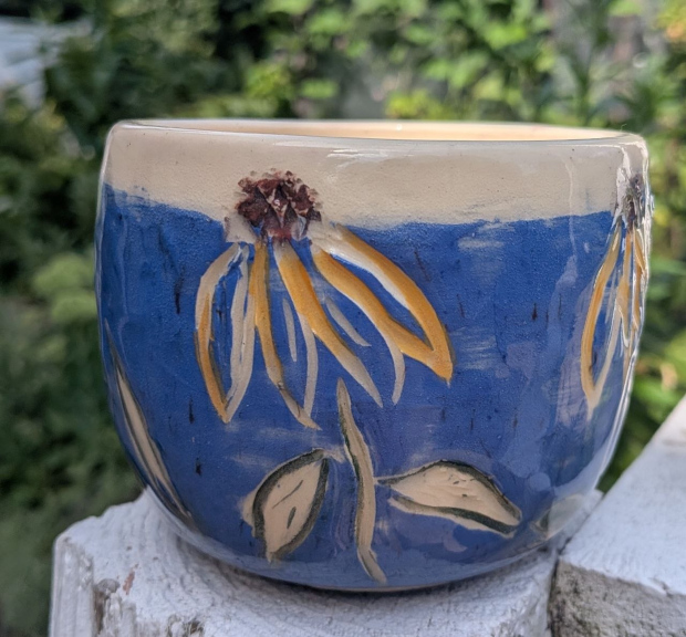 Rudbeckia pot. Blue slip with underglazes.