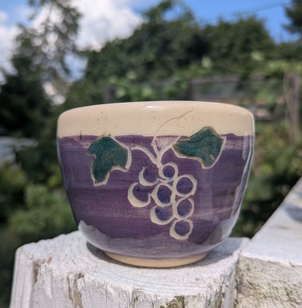 Cup with grapes. Purple slip, violet and hunter green underglazes.
