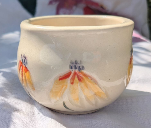 Rudbeckia pot. Yellow, orange, and lavender underglazes. 