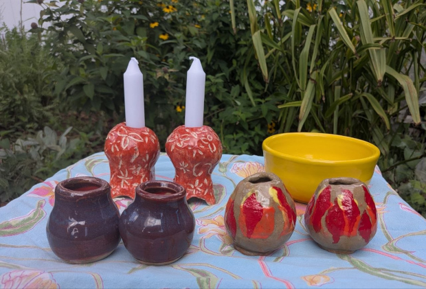 candlesticks in the garden with a yellow bowl