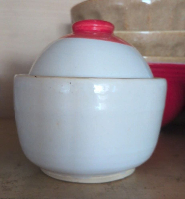 Covered dish with lid. Glossy white glaze with a bit of bright red.